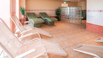 Zona de spa con sillones de descanso y suelo de baldosas.