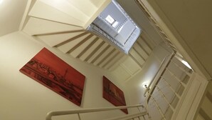 A staircase with white railings and a handrail, leading to an upper floor. - Hotel Am Volksgarten (Düsseldorf)