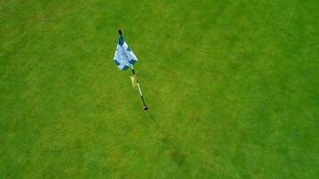 Golfers can tee off from the lush green fairway.