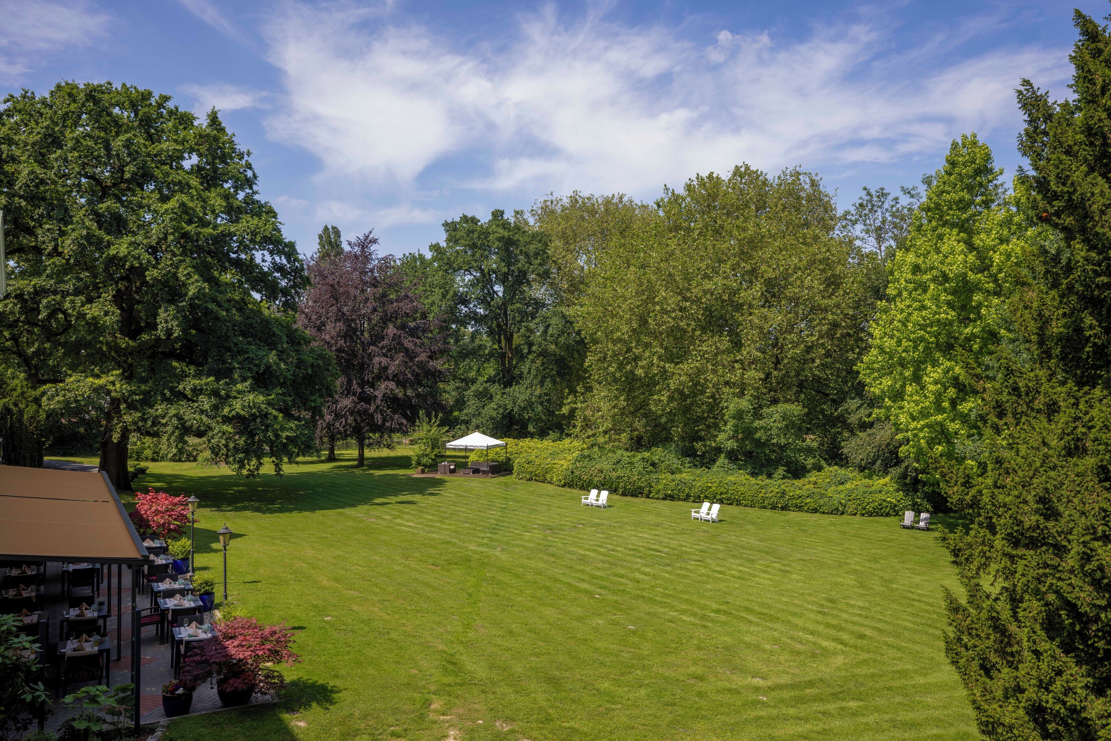 A well-maintained lawn with outdoor seating and a gazebo.