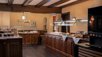 A buffet setup with a variety of food items and a coffee machine.