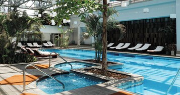 Una piscina techada, sillones reclinables de piscina