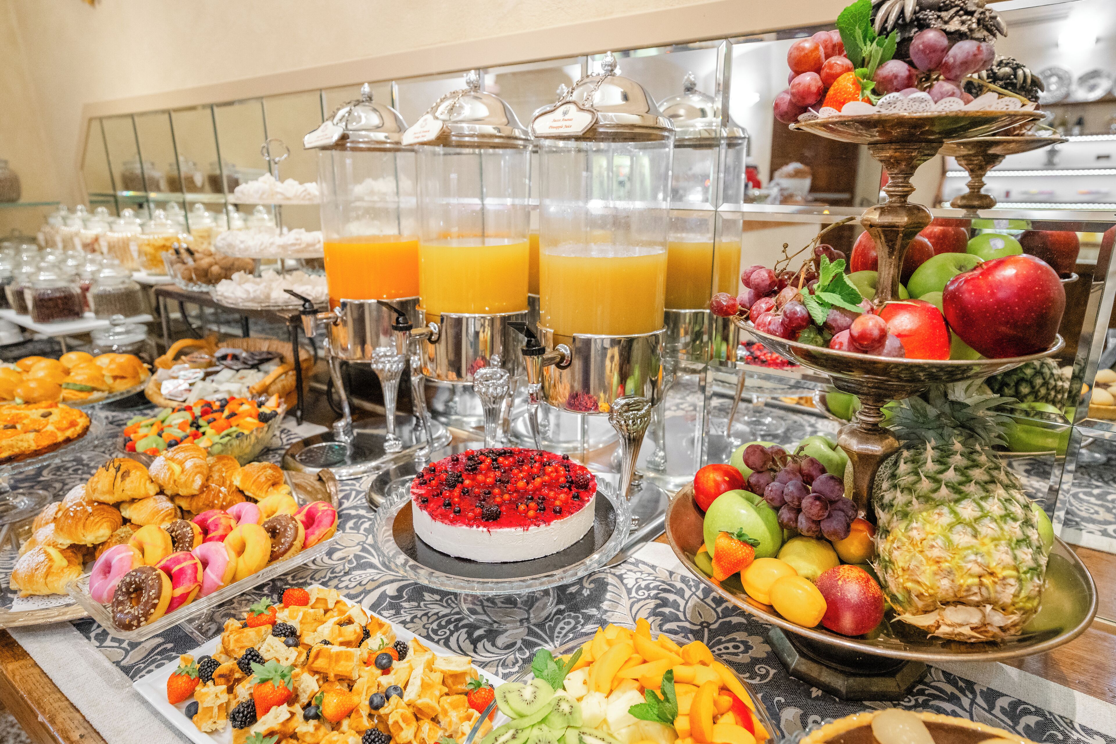 Un bufé con diversas opciones de comida y una presentación de frutas.