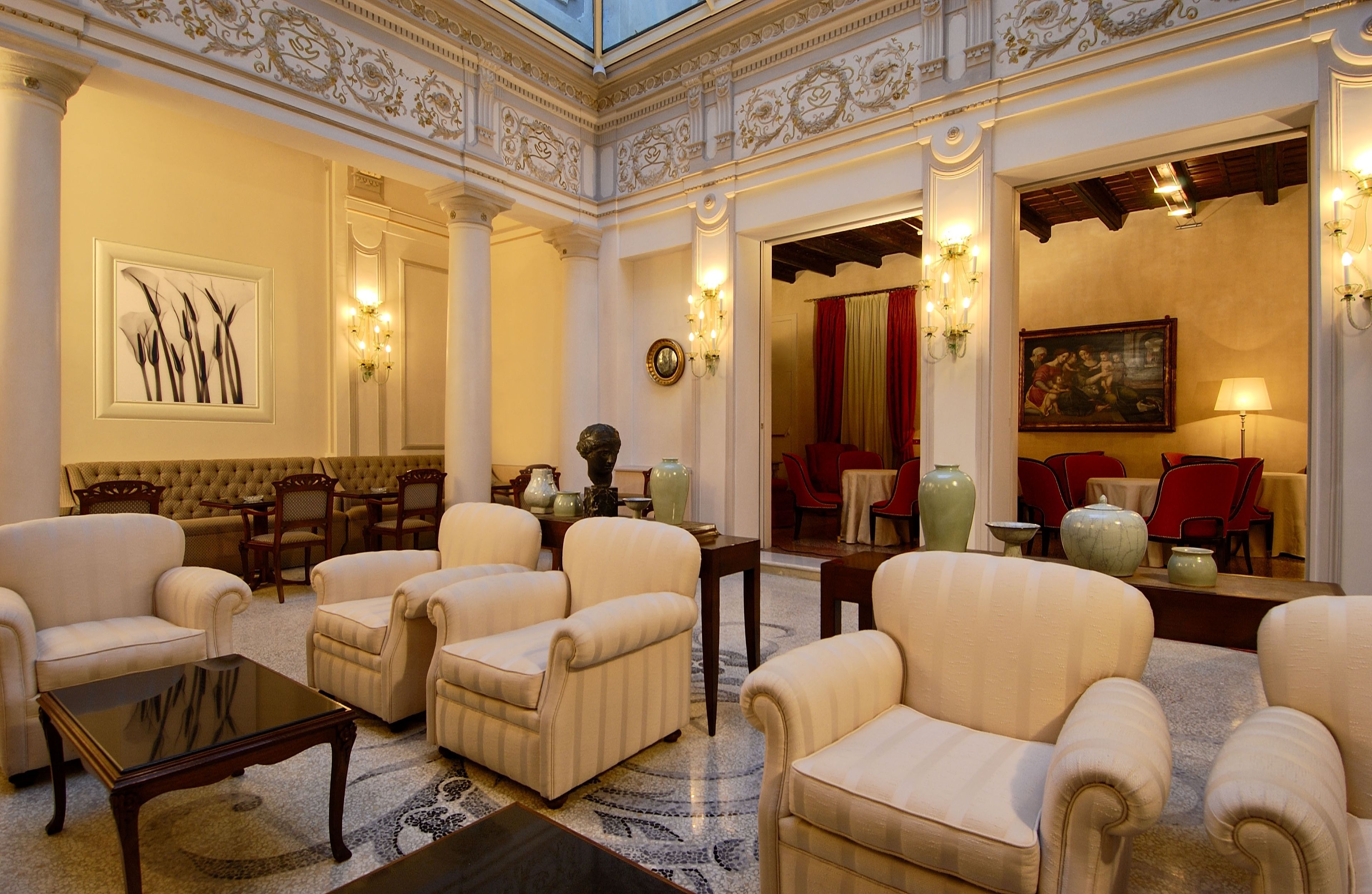 A luxurious lobby with ornate columns, plush seating, and elegant decor.