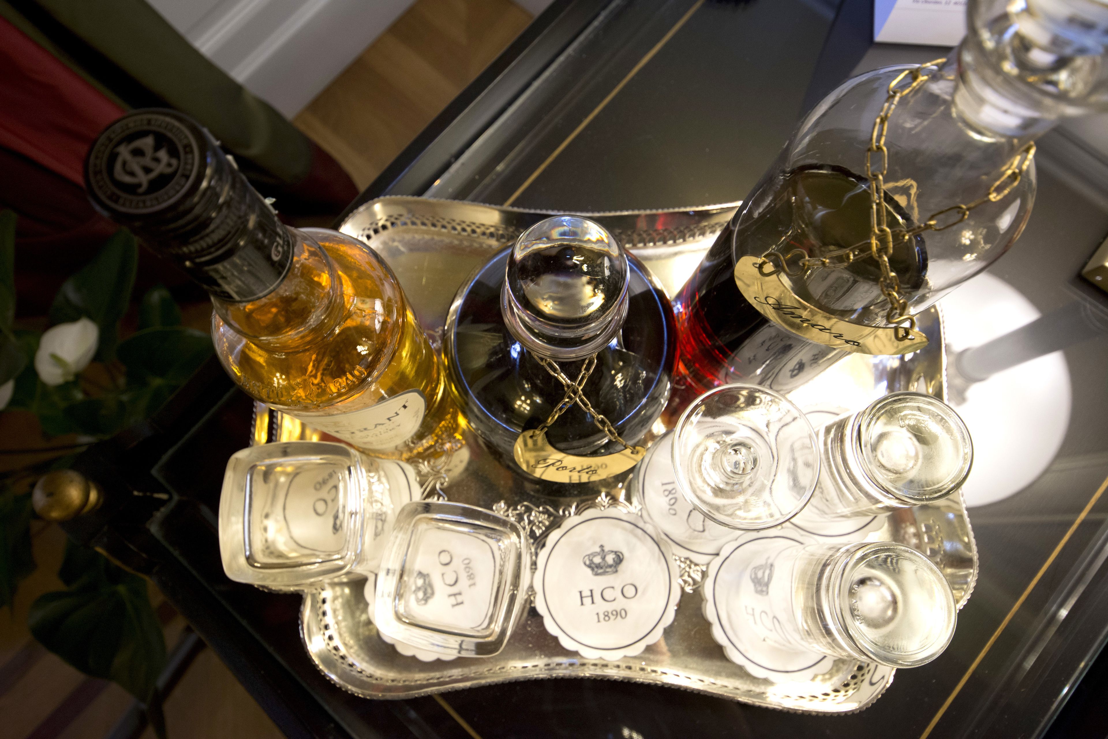 A tray with various bottles and glasses, including a bottle labeled "HCO 1890".
