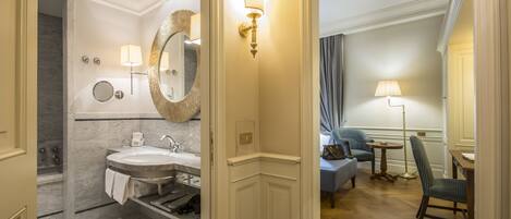 A modern bathroom with a double sink, a large mirror, and a vanity.