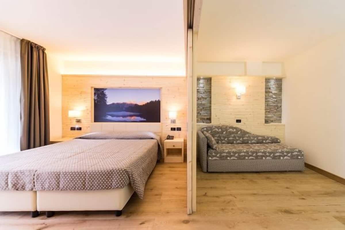 Junior Quadruple Room | 1 bedroom, down comforters, minibar, in-room safe