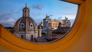 A view through a window of a historic building with a dome and classical architecture. - Cosmopolita Rome Colosseum, Tapestry Collection by Hilton (Rome)