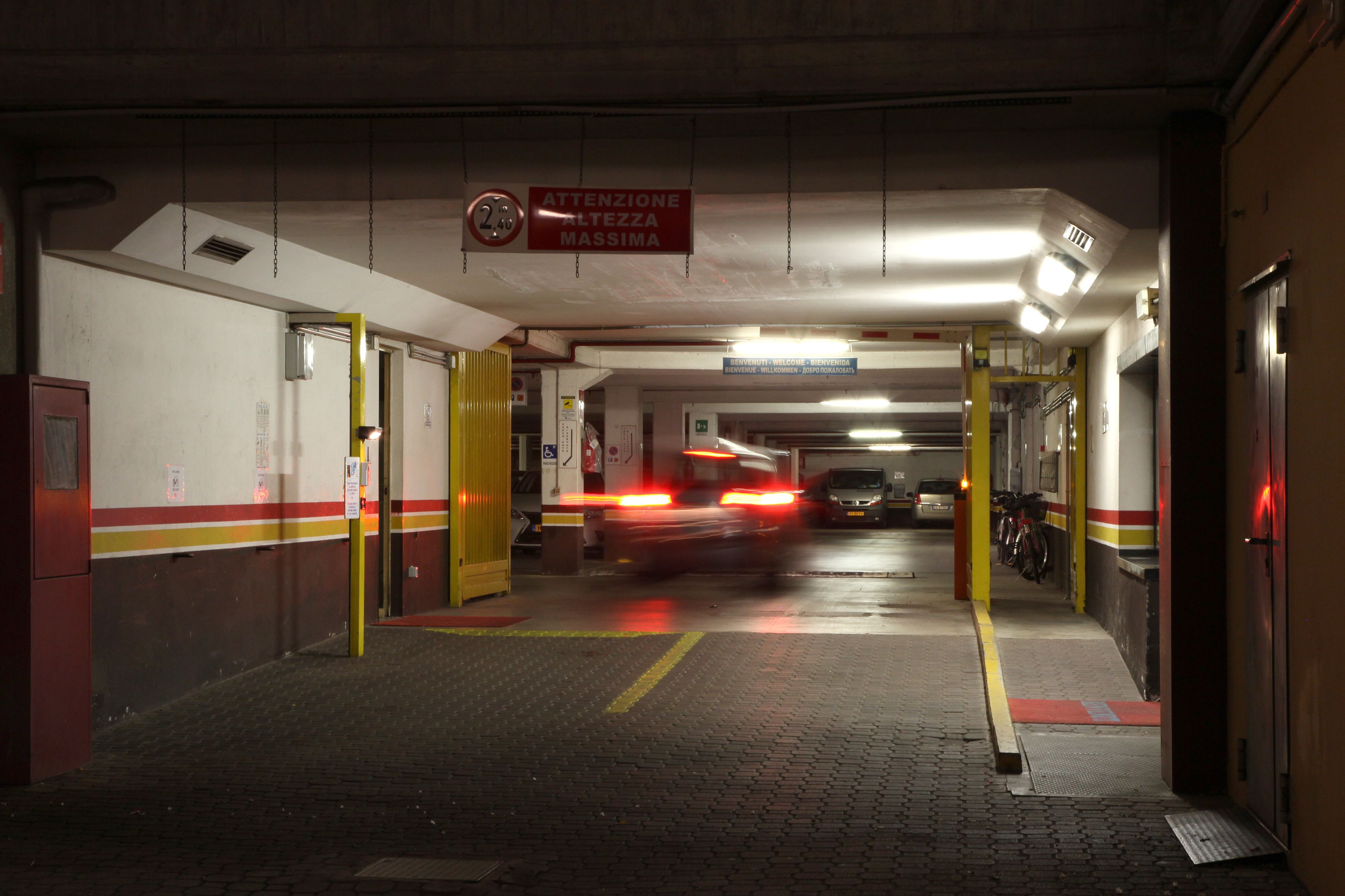 A parking garage with a sign indicating maximum height clearance.