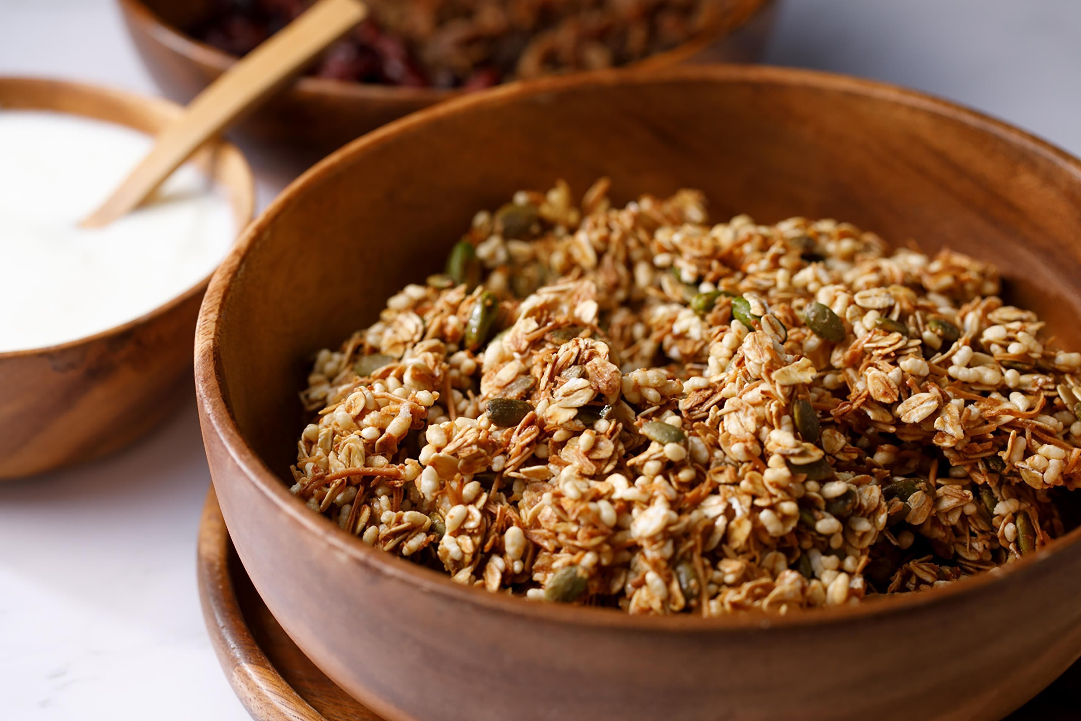 A wooden bowl filled with granola.