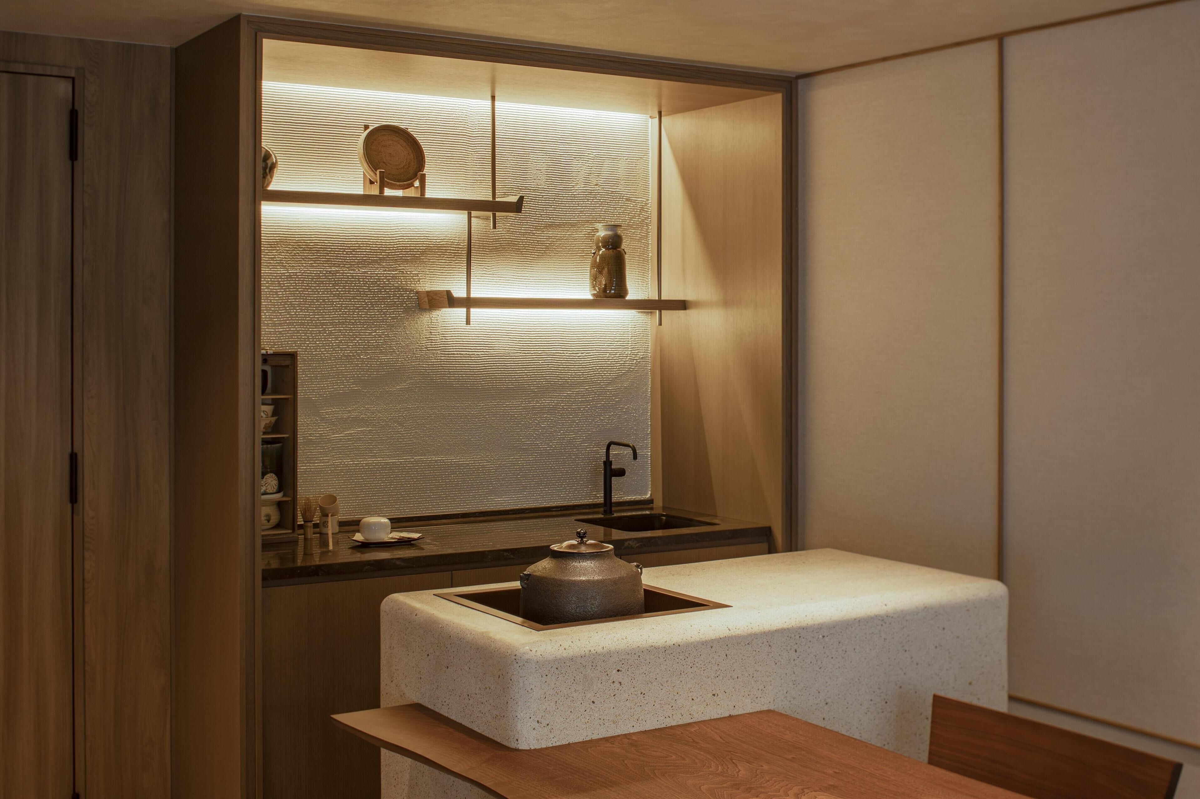 A compact kitchen with a built-in sink, a countertop, and a wooden cabinet.