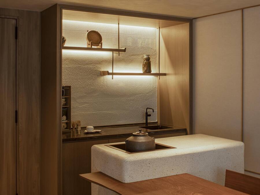A compact kitchen with a built-in sink, a countertop, and a wooden cabinet.