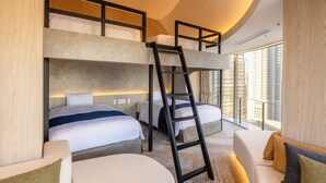 A modern hotel room with bunk beds, a ladder, a sofa, and a large window offering a city view.
