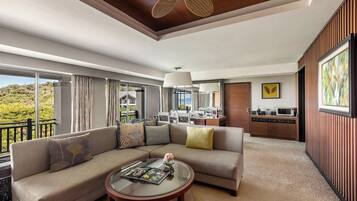 A spacious living area with a sofa, coffee table, and a view of the outdoors.