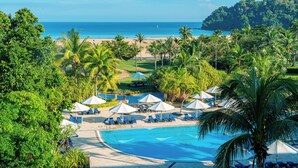 A resort with a swimming pool, beach, and palm trees. - Shangri-La Rasa Ria, Kota Kinabalu (Tuaran)