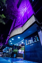 La façade de l’hôtel Laila, avec son entrée imposante et son enseigne lumineuse.