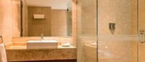 A modern bathroom with a glass-enclosed shower, a wooden vanity, and a large mirror.