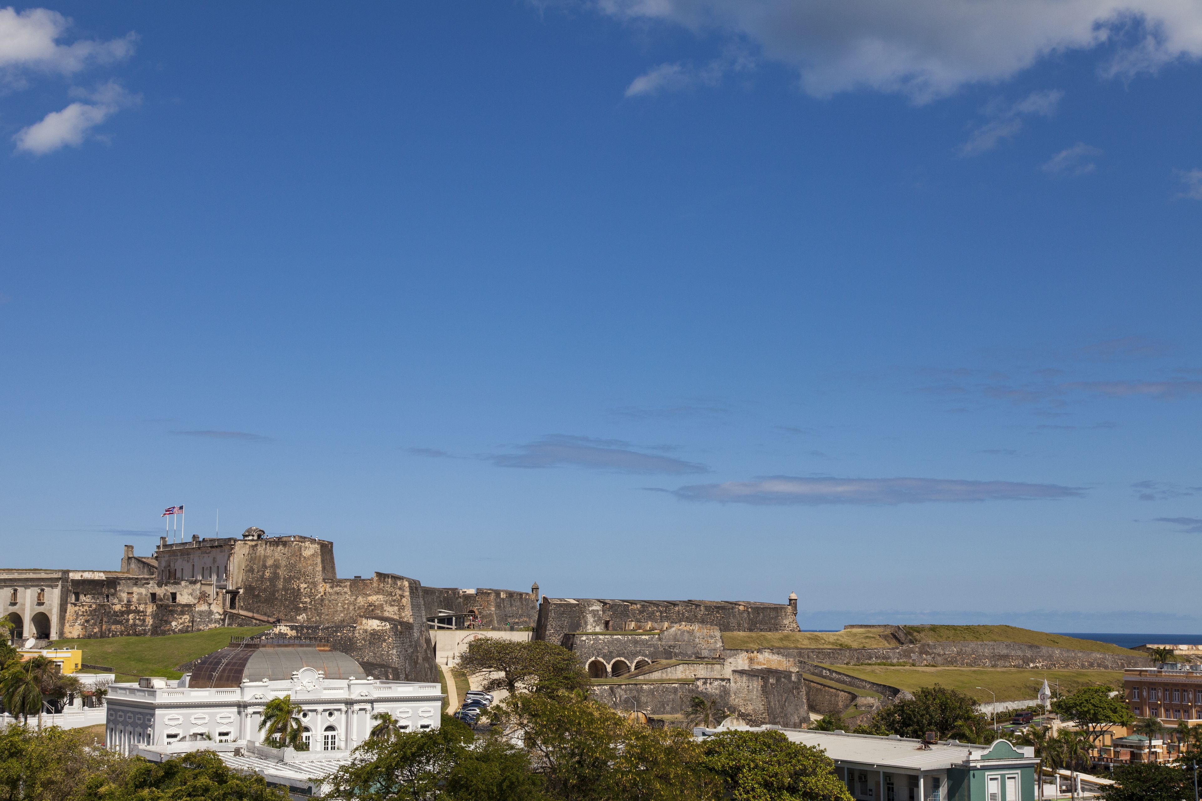 A historic fort with a large dome, surrounded by buildings and greenery.