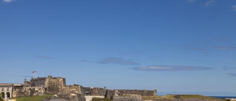 A historic fort with a large dome, surrounded by buildings and greenery.