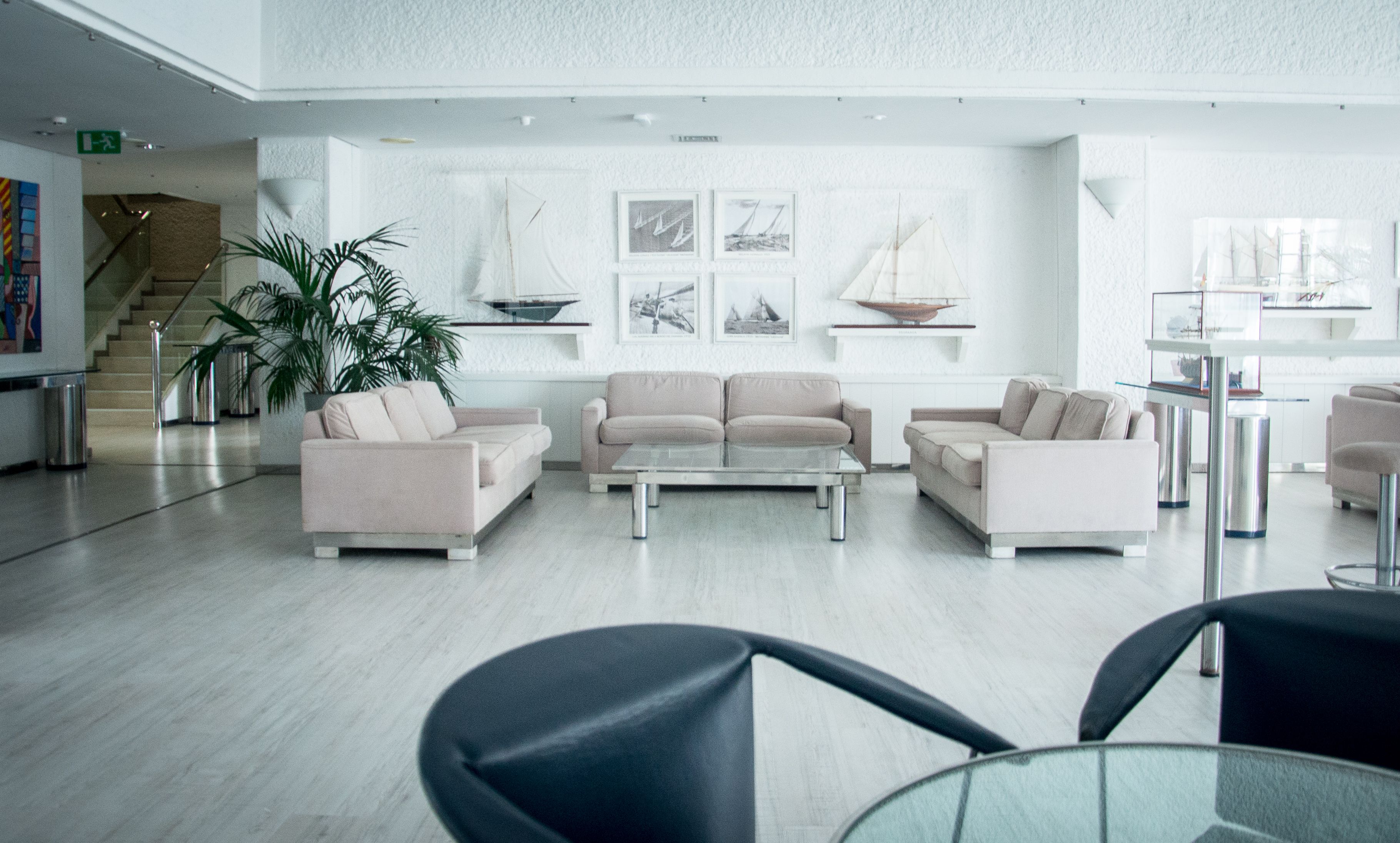 A modern lobby with sofas, a coffee table, and artwork on the walls.
