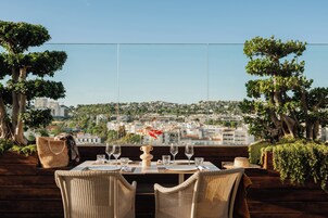 A table set for dining with a view of a cityscape.
