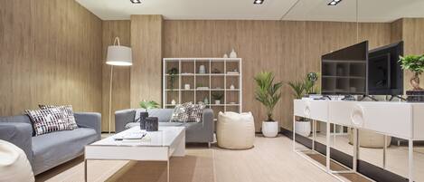 A modern living room with a sofa, coffee table, and a white cabinet.