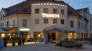 A hotel with a prominent 'Thessoni' sign, a classic design, and a welcoming entrance with a covered area. - Boutiquehotel Thessoni Classic Zürich (Regensdorf)
