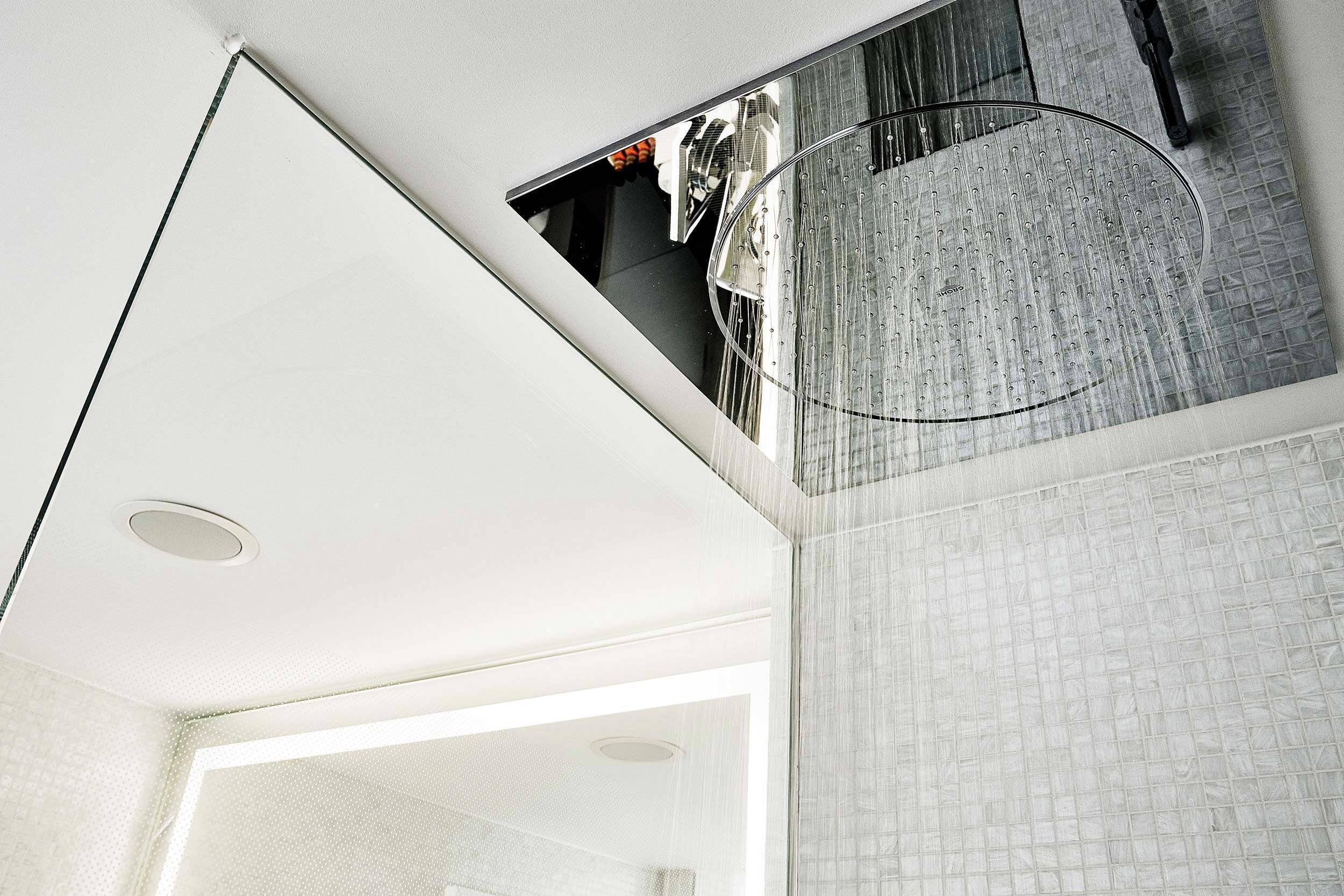 A modern interior with a white ceiling, a circular skylight, and a textured wall.
