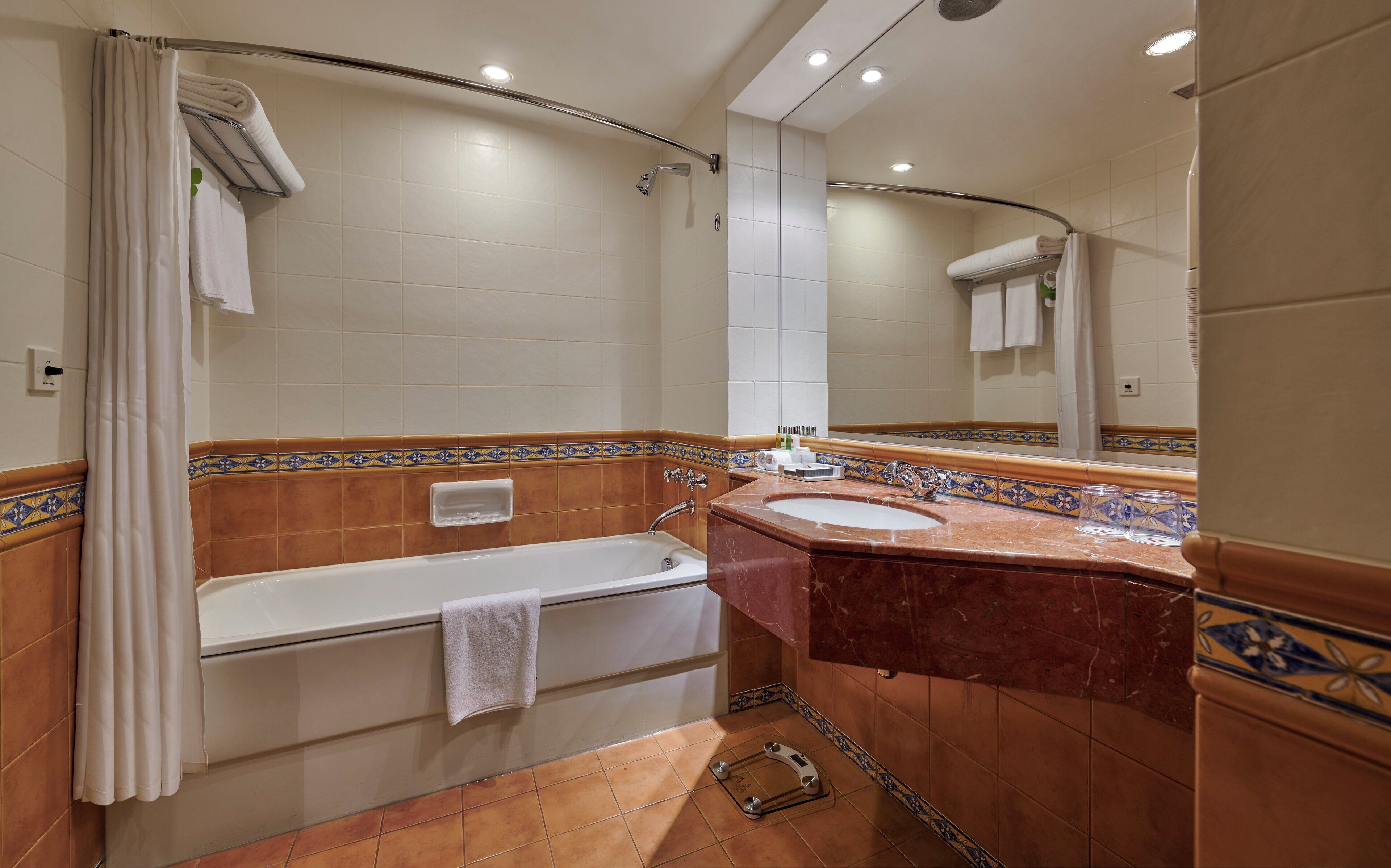 A bathroom with a bathtub, a sink, and a shower.