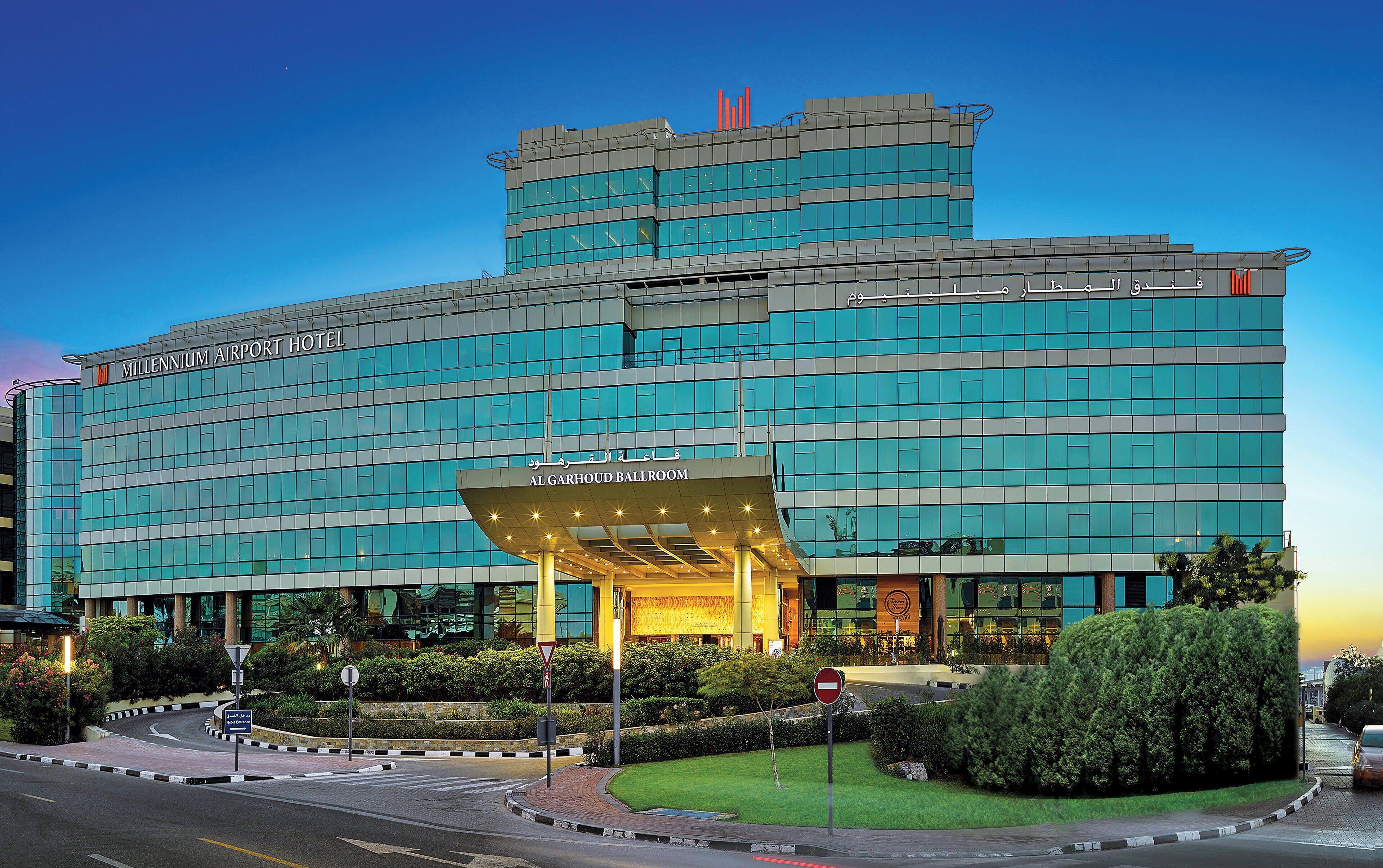 A hotel with a modern design, featuring a prominent entrance and multiple floors.