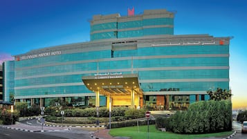 A hotel with a modern design, featuring a prominent entrance and multiple floors.
