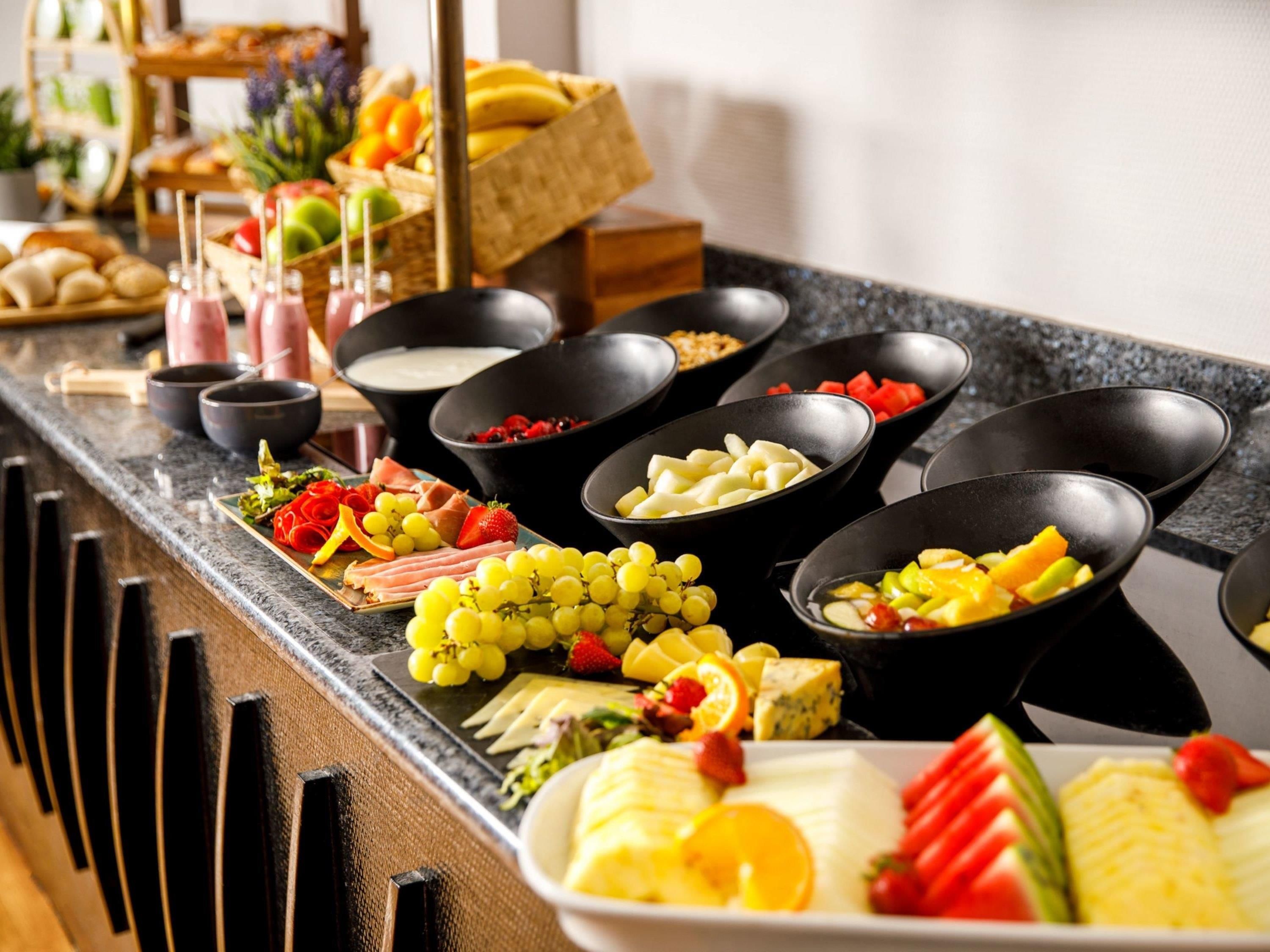 A buffet with various food items and beverages.