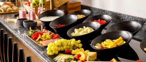 A buffet with various food items and beverages.