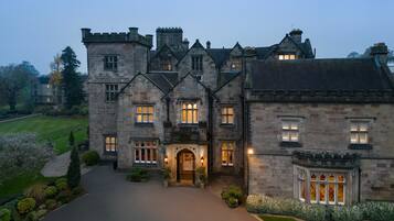 A large stone building with multiple windows and a central entrance.