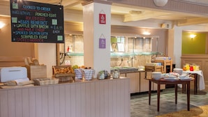 A breakfast bar with a chalkboard menu listing items like poached eggs and smoked salmon. - Holiday Inn Ipswich Orwell by IHG (Ipswich)
