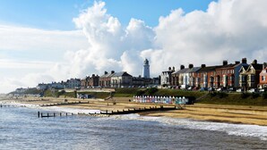 A coastal town with a lighthouse, terraced houses, and a promenade by the sea. - Holiday Inn Ipswich Orwell by IHG (Ipswich)