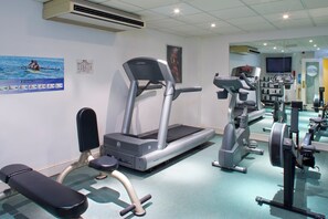 A gym with treadmills, weight machines, and a bench. - Holiday Inn Milton Keynes - East M1, Jct. 14 by IHG (Newport Pagnell)