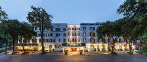 A grand hotel with a central entrance, multiple floors, and a well-lit facade. - Sofitel Legend Metropole Hanoi (Hanoi)