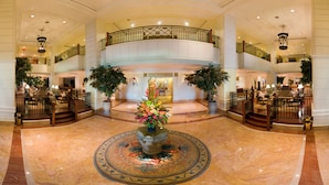 A spacious lobby with a central floral arrangement, multiple levels with balconies, and a marble floor. - The Great Duke Phnom Penh (Phnom Penh)