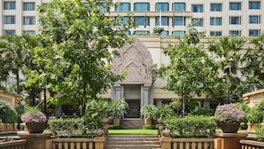 A hotel with a large, symmetrical facade, multiple windows, and a central entrance with steps. - The Great Duke Phnom Penh (Phnom Penh)