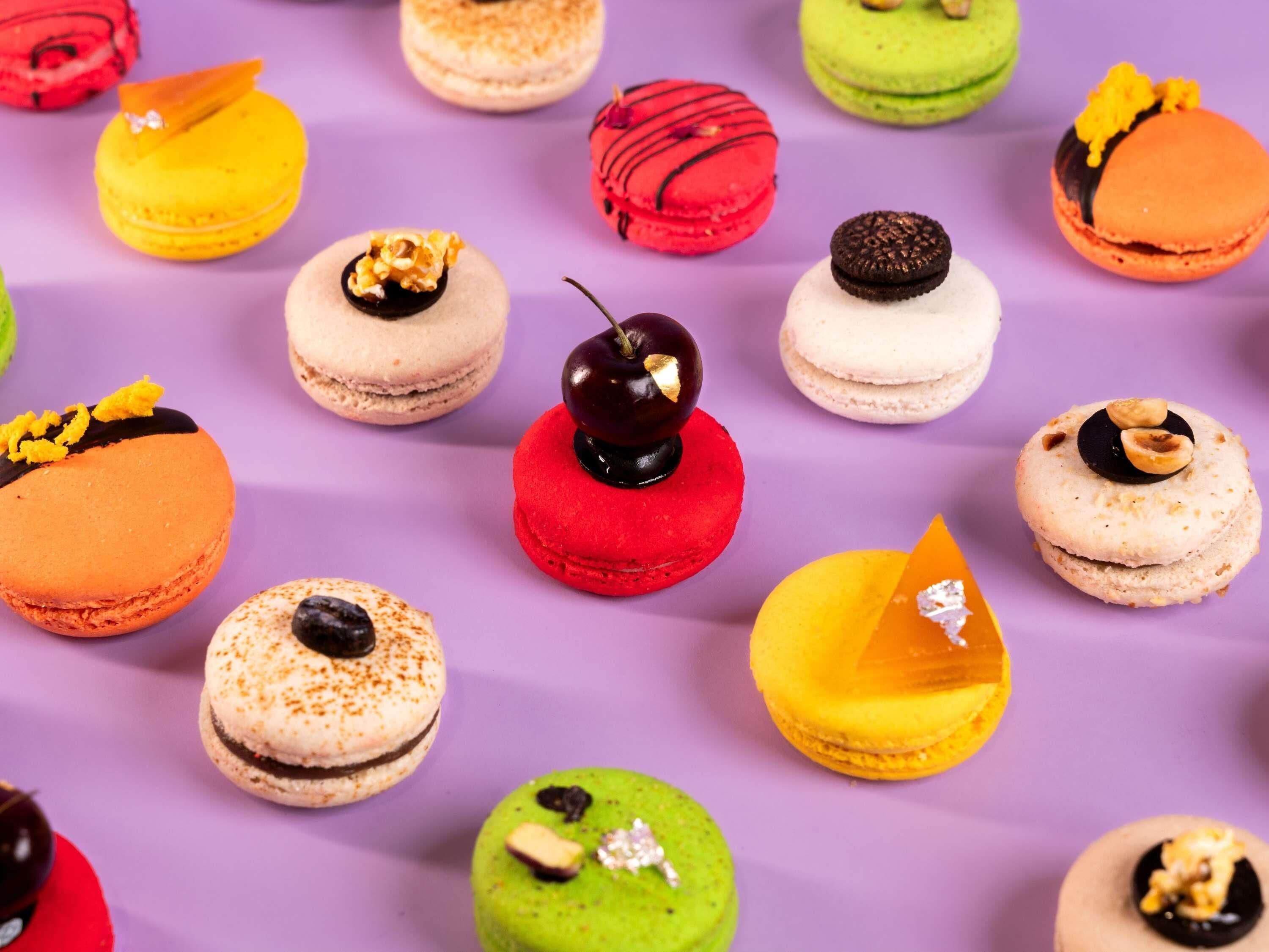 A variety of macarons with different toppings and colors.