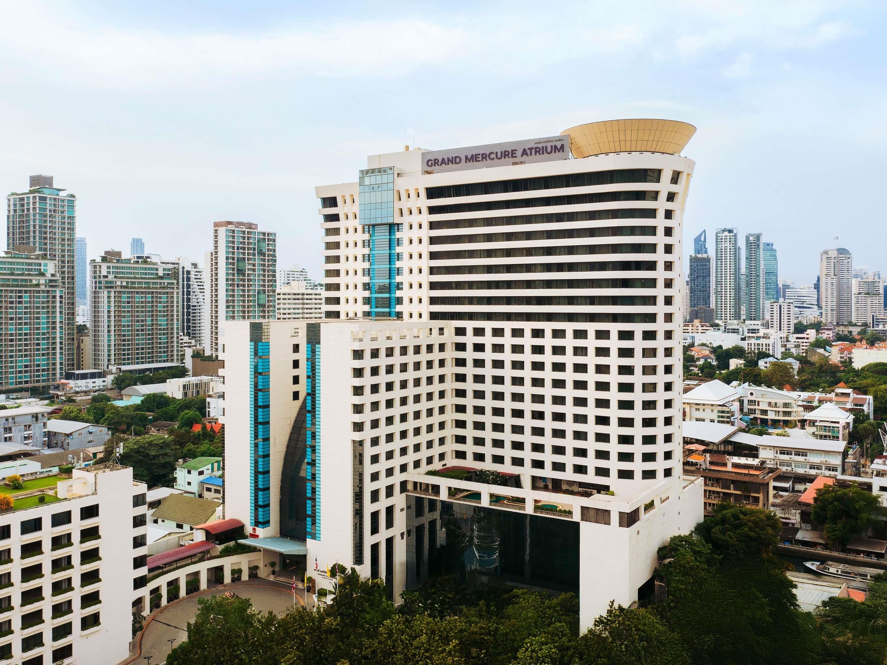 A high-rise building with a prominent sign reading 'GRAND MERCURE ATRIUM'.