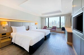 Relax in a spacious room with two beds, a flat-screen TV, and a city view.