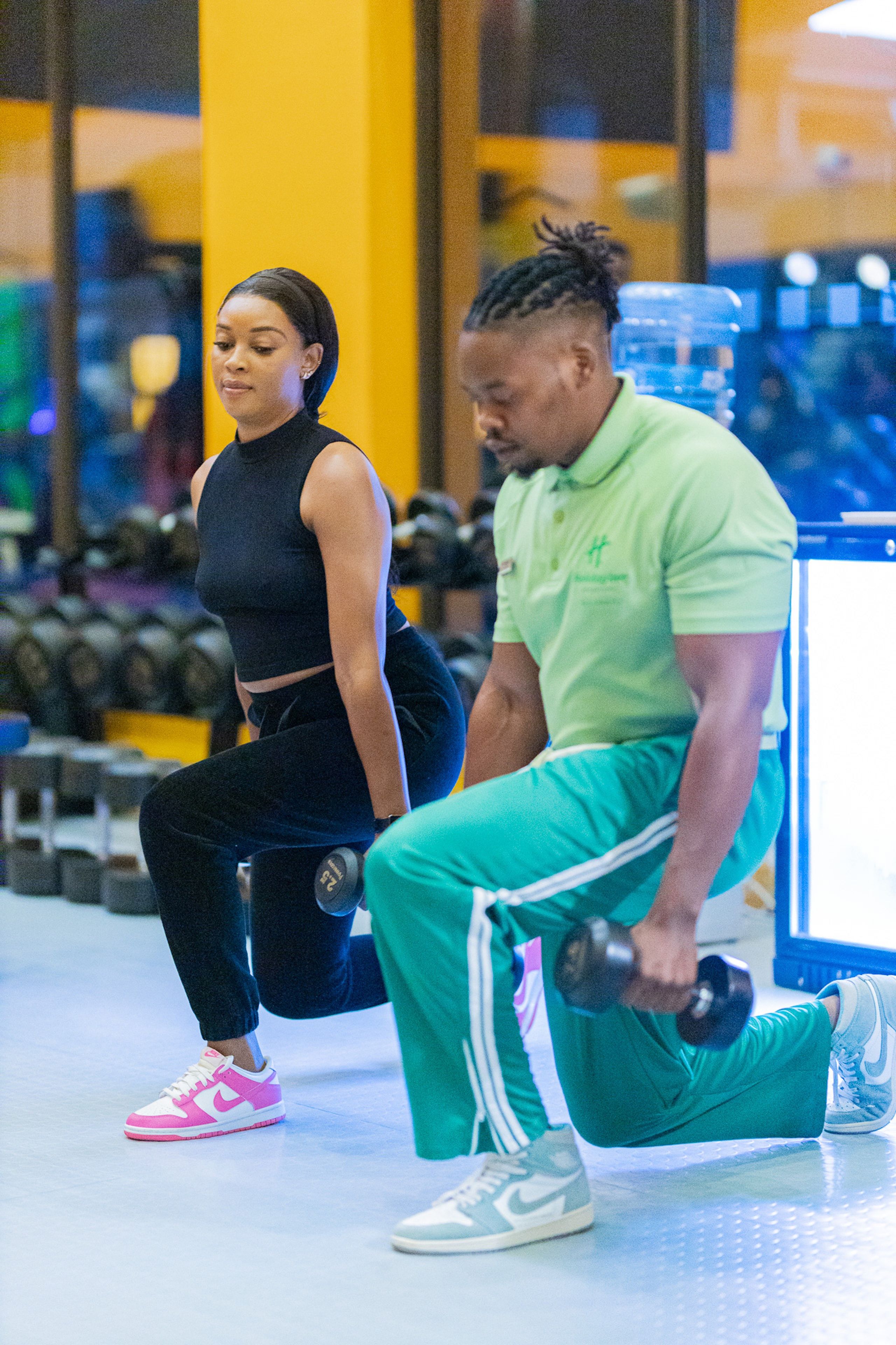 A gym with exercise equipment and weights.