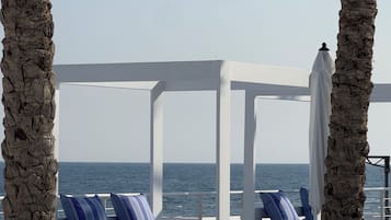 Seasonal outdoor pool, open 9:00 AM to 6:00 PM, pool umbrellas