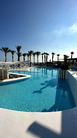 Seasonal outdoor pool, open 9:00 AM to 6:00 PM, pool umbrellas