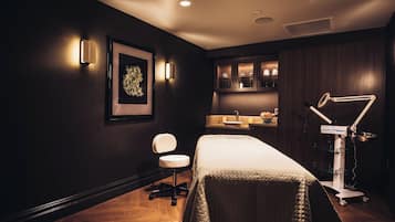 Relax in a serene space with a neatly made bed, a comfortable chair, and a desk for work or leisure.