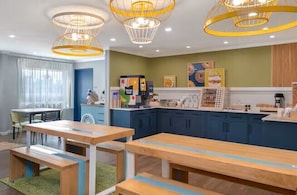 A modern kitchen with wooden countertops and a dining area with benches.