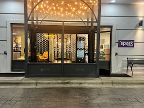A hotel entrance with a glass facade, a bench outside, and a sign for 'spark by Hilton'. - Spark by Hilton Asheville Blue Ridge Parkway (Asheville)