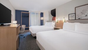 A hotel room with two beds, a desk, a chair, and a TV. - Spark by Hilton Asheville Blue Ridge Parkway (Asheville)